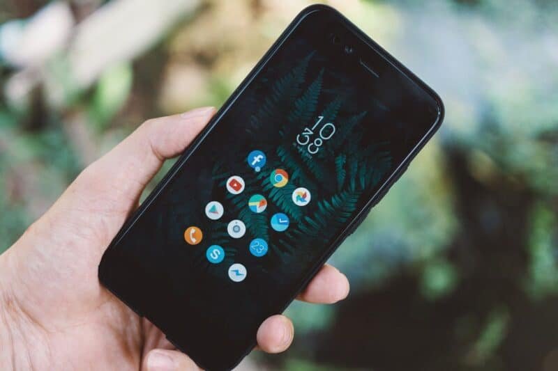 Comparação entre tela original vs genérica de celular sobre bancada de reparo